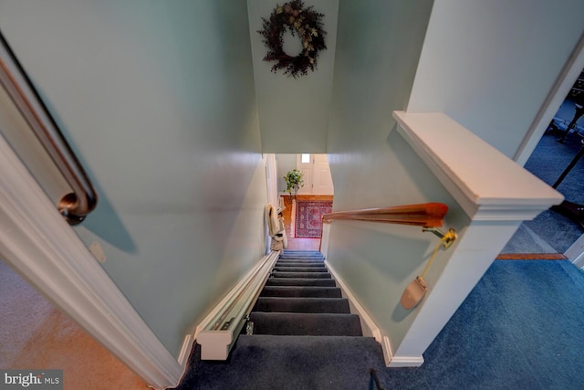 stairway with carpet flooring and baseboards