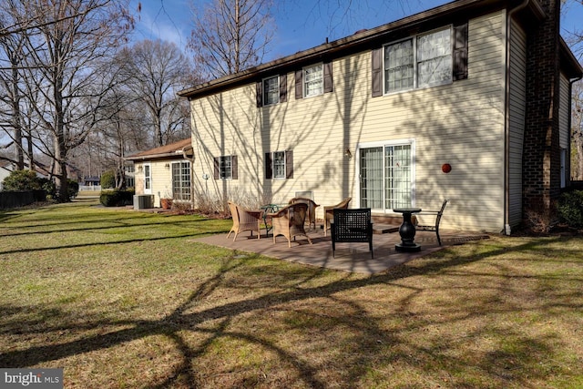 rear view of property featuring central AC, a patio, and a lawn