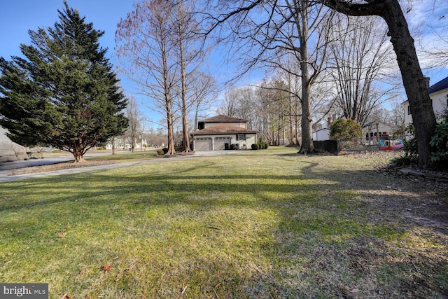 view of yard featuring an outbuilding and an attached garage