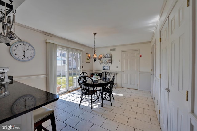 dining area featuring ornamental molding, visible vents, and light tile patterned flooring