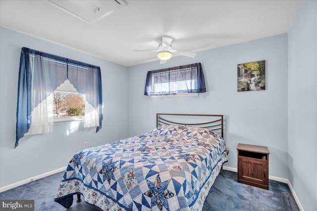 carpeted bedroom featuring multiple windows, a ceiling fan, and baseboards