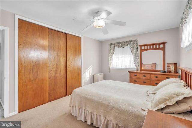 bedroom featuring a ceiling fan, a closet, and carpet flooring