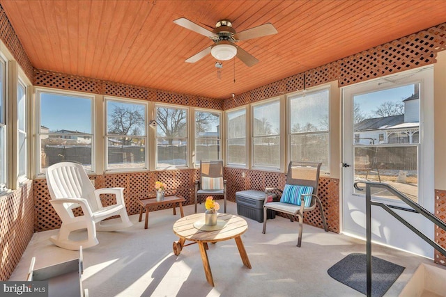 sunroom / solarium with wooden ceiling and a ceiling fan