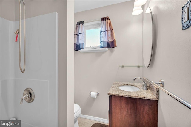 bathroom with a shower, toilet, vanity, and baseboards