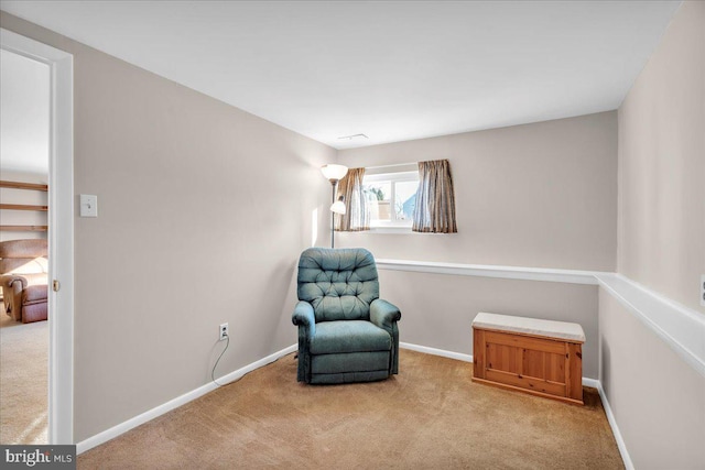 living area featuring baseboards and carpet flooring