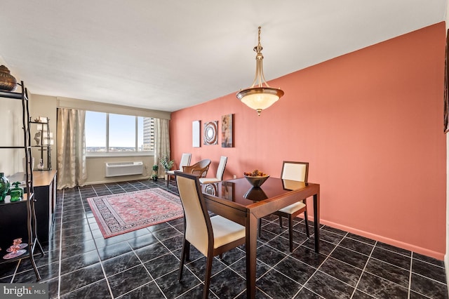 dining space with a wall mounted AC and tile patterned floors