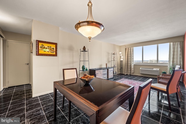 dining area featuring baseboards, dark tile patterned flooring, and a wall mounted AC