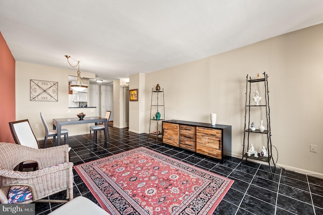 interior space with dark tile patterned flooring and baseboards