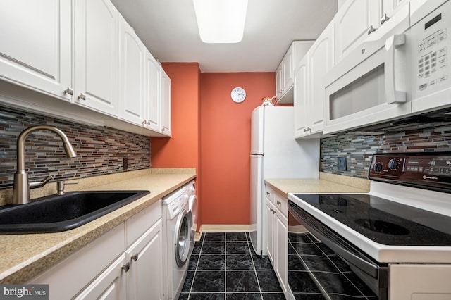 kitchen with electric stove, washer / clothes dryer, white microwave, white cabinetry, and a sink