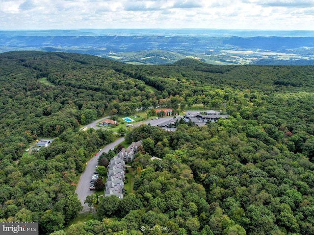 aerial view with a mountain view and a wooded view