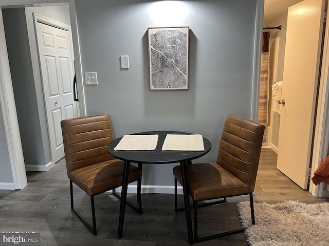 dining room featuring baseboards and wood finished floors