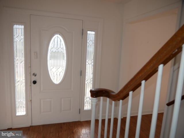 foyer with stairs and wood finished floors