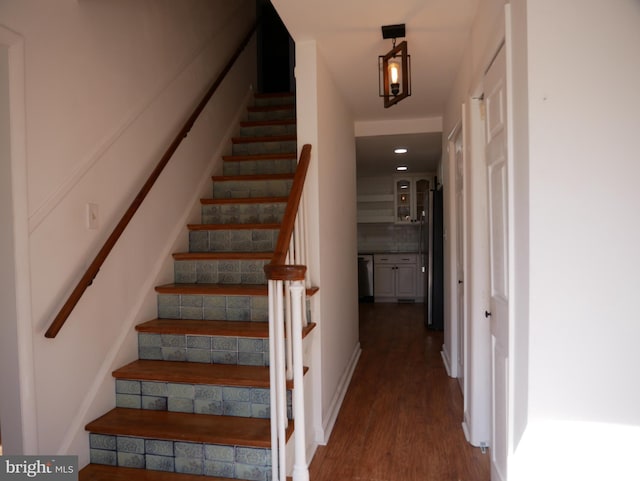 stairs featuring wood finished floors