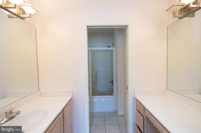 bathroom featuring combined bath / shower with glass door, vanity, and tile patterned floors