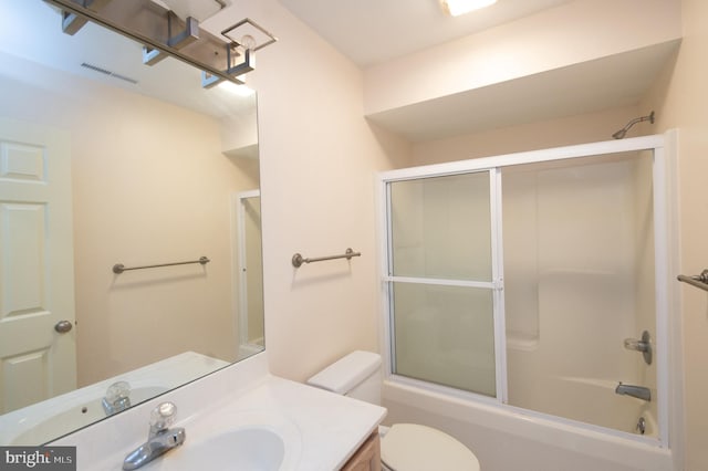 bathroom with enclosed tub / shower combo, visible vents, vanity, and toilet