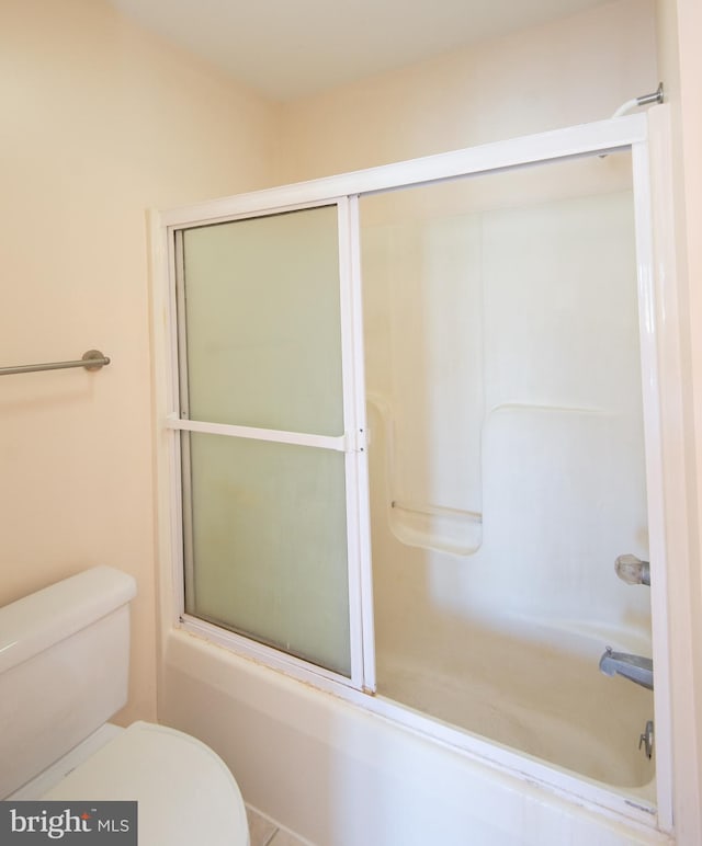 full bath featuring shower / bath combination with glass door and toilet