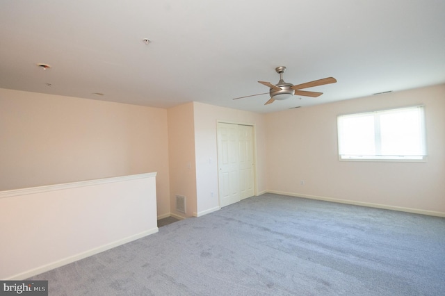 unfurnished bedroom featuring visible vents, baseboards, ceiling fan, carpet floors, and a closet