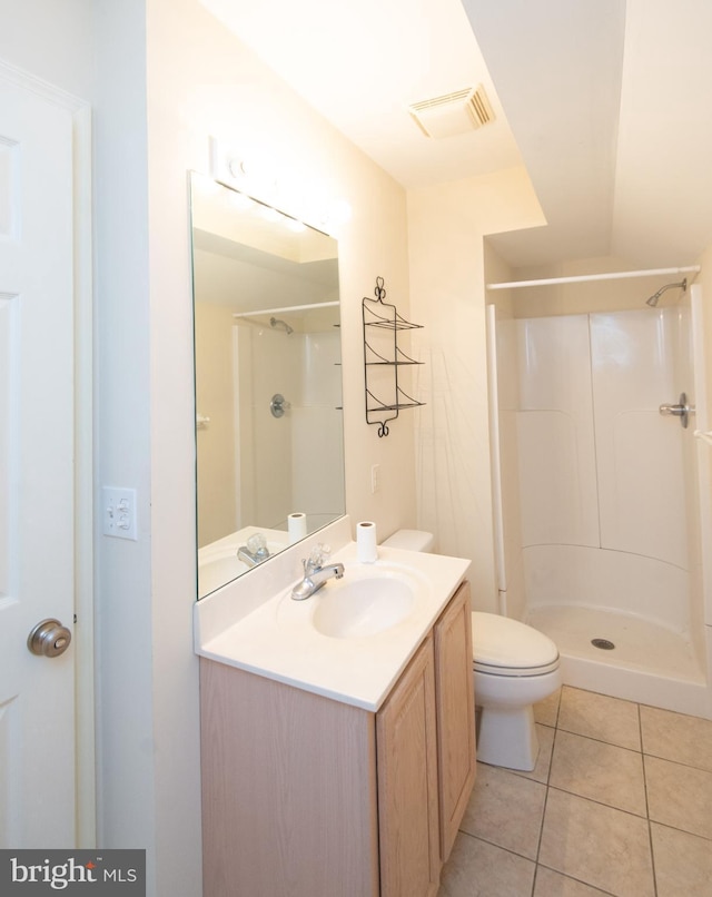 full bathroom featuring a stall shower, tile patterned flooring, visible vents, and vanity