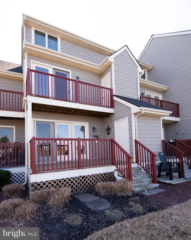 back of house featuring a balcony