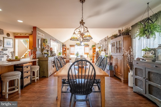 dining area with a notable chandelier, vaulted ceiling, dark wood finished floors, and recessed lighting