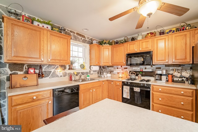 kitchen featuring black appliances, tasteful backsplash, a sink, and light countertops