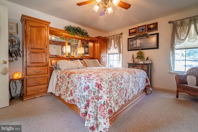 bedroom featuring light carpet, ceiling fan, and baseboards