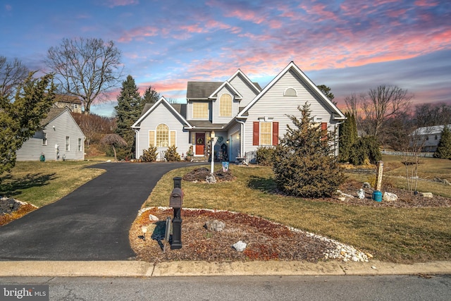 traditional home with driveway and a front lawn