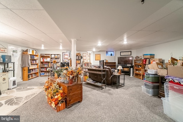 finished basement featuring carpet and a paneled ceiling