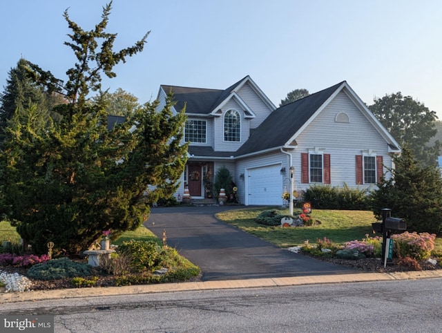 view of front of property with aphalt driveway, a front lawn, and an attached garage