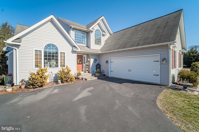 traditional-style house featuring driveway and an attached garage