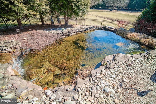 view of swimming pool with a fenced backyard