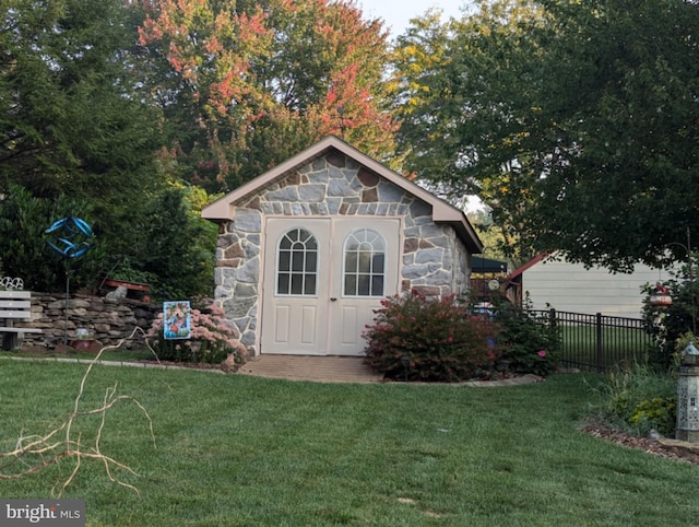 view of shed featuring fence