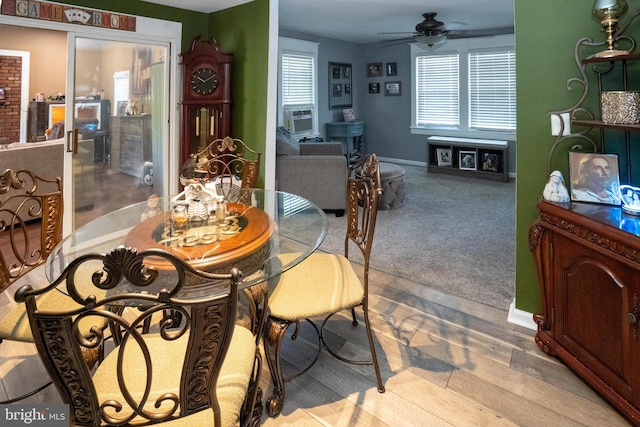 dining space featuring carpet flooring, cooling unit, a ceiling fan, and baseboards