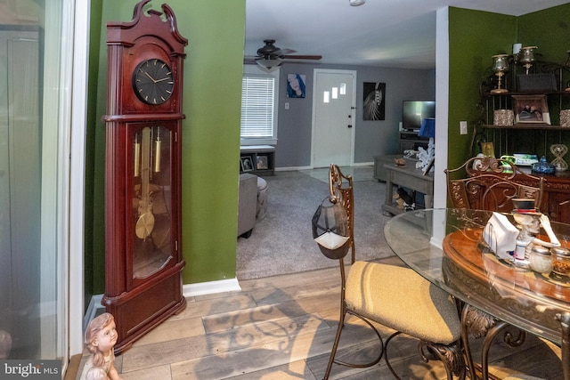 dining area featuring a ceiling fan and baseboards