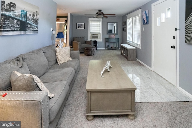 living room featuring cooling unit, a ceiling fan, and baseboards