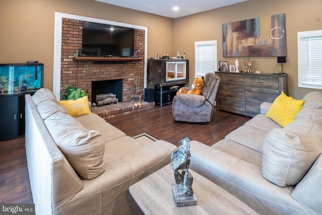 living area featuring recessed lighting, a brick fireplace, wood finished floors, and a healthy amount of sunlight