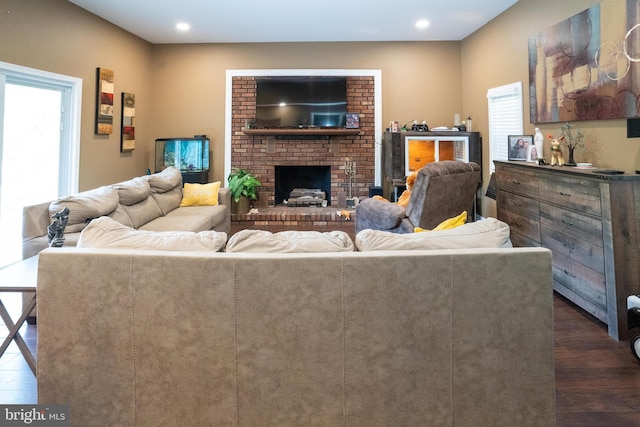 living area featuring dark wood-style floors, recessed lighting, and a fireplace