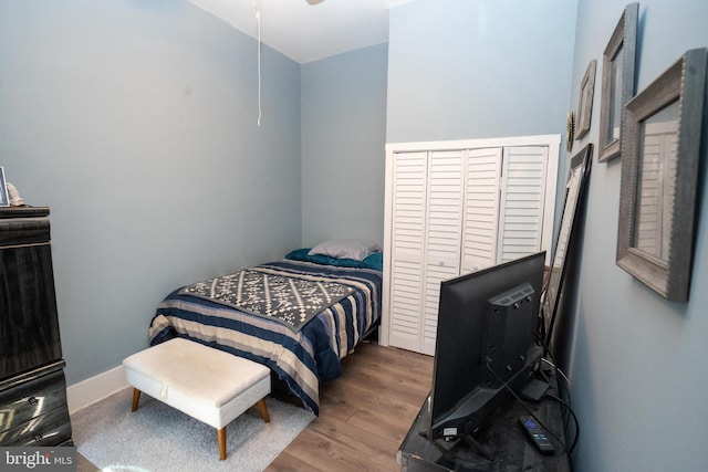 bedroom with wood finished floors and baseboards