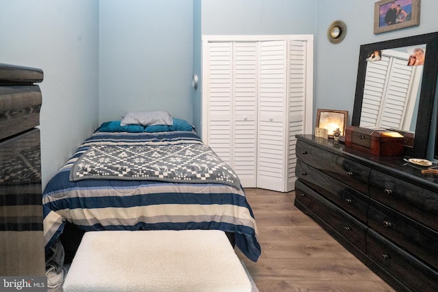 bedroom with a closet and wood finished floors