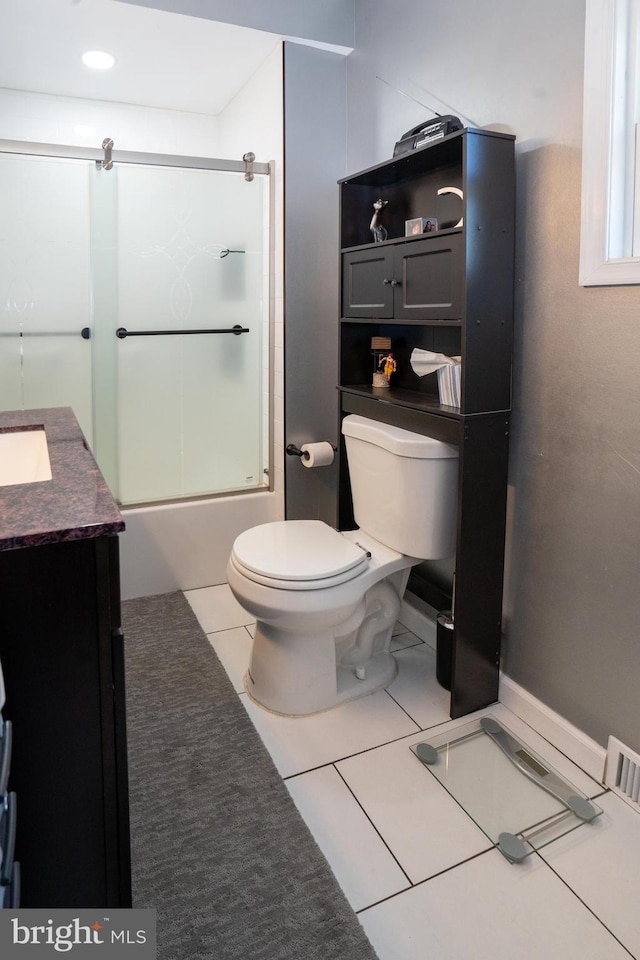 bathroom featuring shower / bath combination with glass door, vanity, toilet, and tile patterned floors