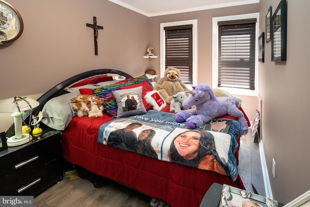 bedroom featuring crown molding and wood finished floors