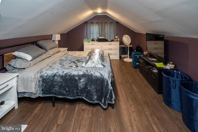 bedroom featuring lofted ceiling and wood finished floors