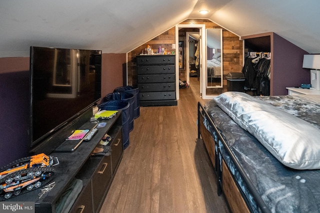 bedroom featuring lofted ceiling, a closet, and wood finished floors