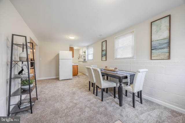 dining area featuring light colored carpet