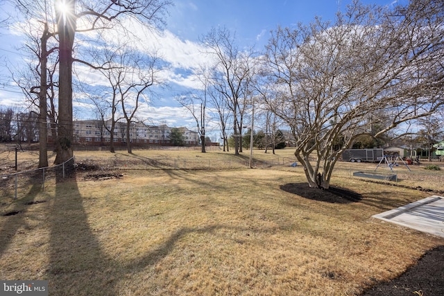 view of yard with fence and a playground