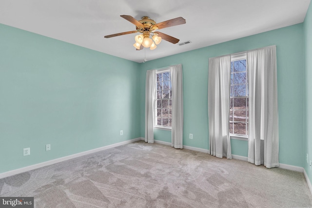 carpeted empty room with visible vents, baseboards, and a healthy amount of sunlight