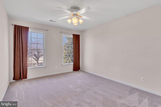 unfurnished room with visible vents, baseboards, ceiling fan, and carpet flooring