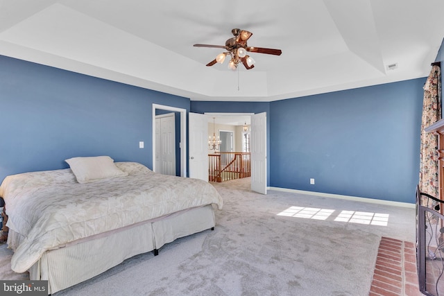 bedroom featuring a tray ceiling, baseboards, carpet, and visible vents