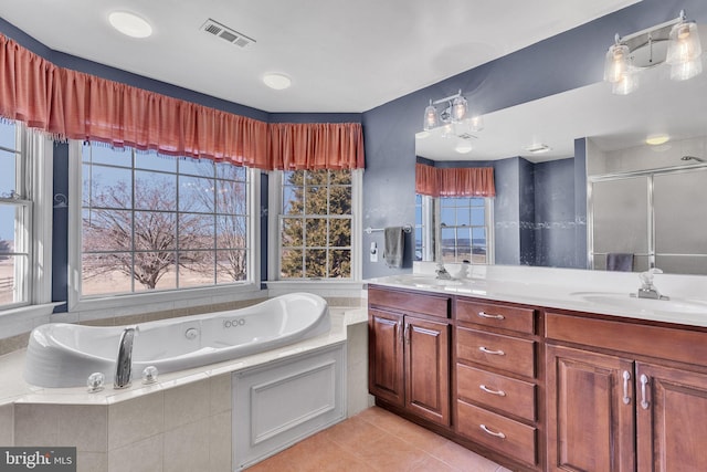 full bath with visible vents, a sink, tile patterned flooring, double vanity, and a whirlpool tub