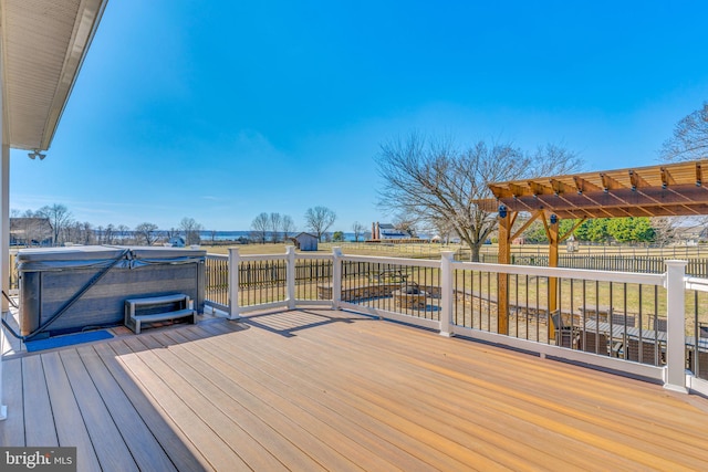 deck featuring fence and a hot tub